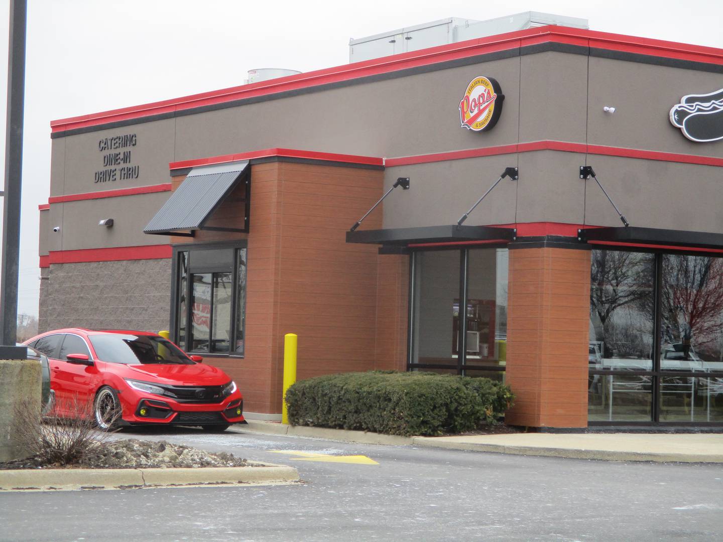 A car pulls up to the drive-thru window at Pop's Italian Beef and Sausage on Jefferson Street in Joliet on Thursday, Feb. 24, 2022.