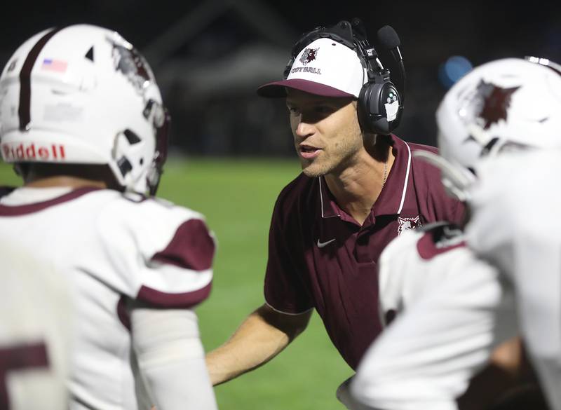 Prairie Ridge Head Coach Mike Frericks talks to his team during a Fox Valley Conference football game against Cary-Grove on Friday, Aug. 29, 2025, at Cary-Grove High School in Cary.