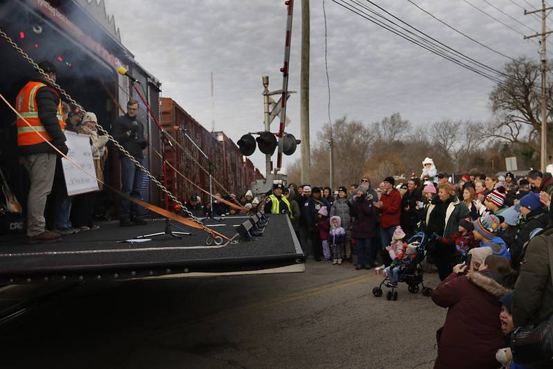 A check for $5,500 is presented to the D300 Food Bank during a stop in Pingree Grove on Wednesday Nov. 27, 2024, by the Canadian Pacific Kansas City Railway 2024 Holiday Train. The holiday train raised food and monetary donations for the D300 Food Pantry during its stop in Pingree Grove.