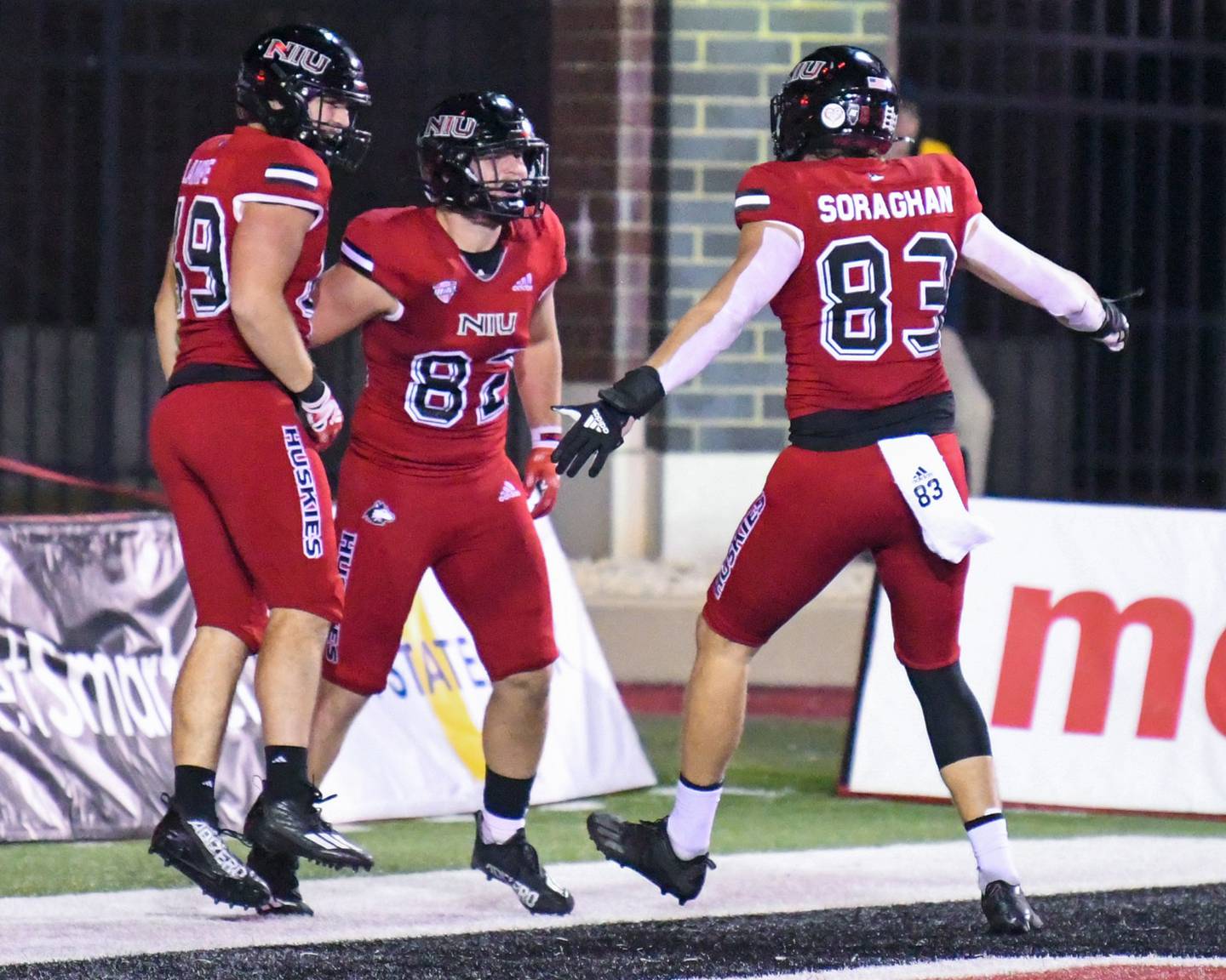NIU tight end Tristen Tewes, 82, celebrates with teammates Brock Lampe, left, and Liam Soraghan, 83, after Tristen scoring a touchdown in the fourth quarter at Huskies Stadium in DeKalb on Wednesday Nov. 2nd.