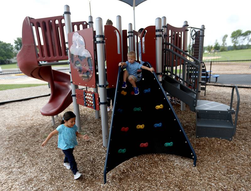 Preschool children play on the playground during the first day of school on Tuesday, Aug. 12, 2025, at District 300's Westfield Community School in Algonquin.