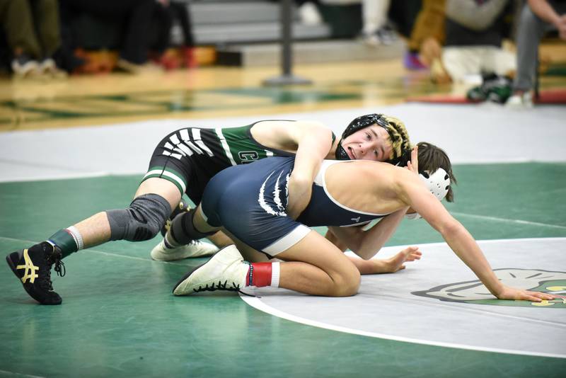 Coal City's Owen Peterson, top, attempts to roll Hope Academy's Nolan Callahan during the 113-pound championship match of the IHSA Class 1A Coal City Sectional Saturday, Feb. 15, 2025.