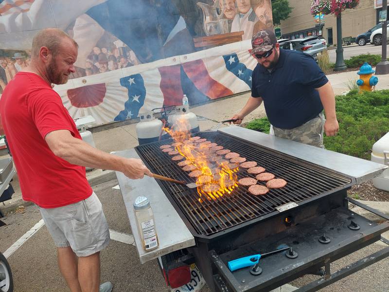 Andy Kovash, of Cheese Shop, and Chris McGrogan, of Handy Foods, grill the burgers Wednesday, Aug. 2, 2023, for Welcomeburger on Jackson Street in Ottawa.