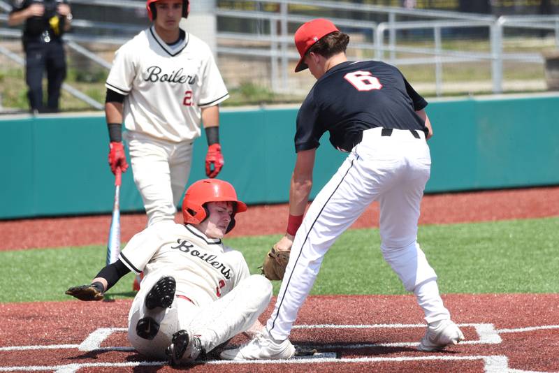 Bradley-Bourbonnais' Keaton Allison, left, slides into home plate for a run under a late tag attempt from Pekin's Matt Stropes during the Class 4A Bradley-Bourbonnais Regional quarterfinals at 315 Sports Park in Bradley Monday, May 25, 2026.