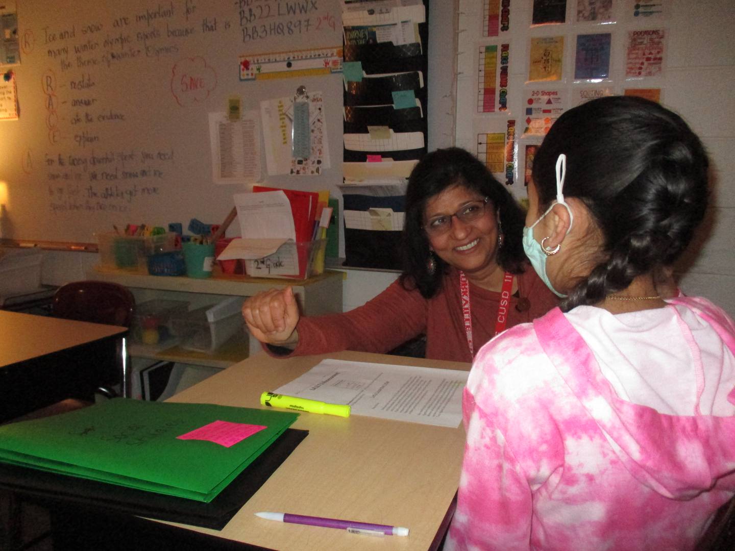English Language Learning teacher Kavita Mahendra offers encouragement to a student at Yorkville's Grande Reserve Elementary School. (Mark Foster -- mfoster@shawmedia.com)