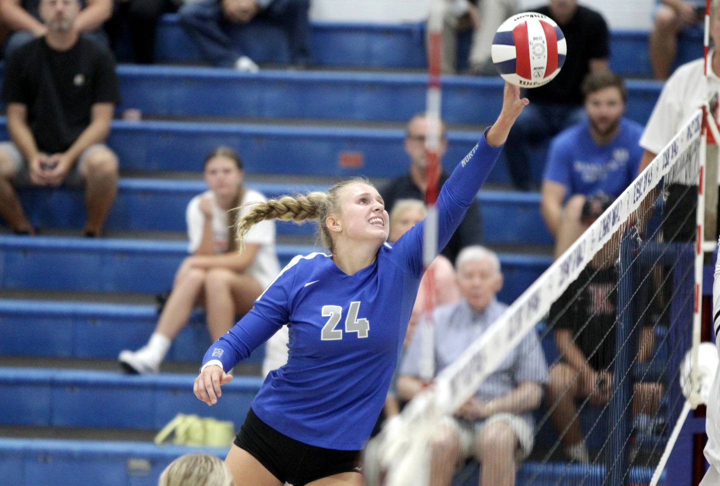 St. Charles North’s Katherine Scherer gets the ball over the net during a game at Rosary in Aurora on Monday, Aug. 21, 2023.