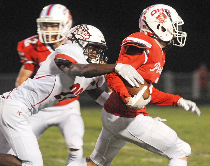 Streator's Jeremiah Brown (22) tries to strip the ball from Ottawa ballcarrier Levi Sheehan during the rivals' meeting Friday, Sept. 3, 2021, at King Field in Ottawa.