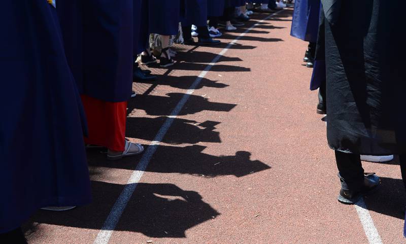 Downers Grove South graduates walk to their seats during the graduation ceremony Sunday May 21, 2023.