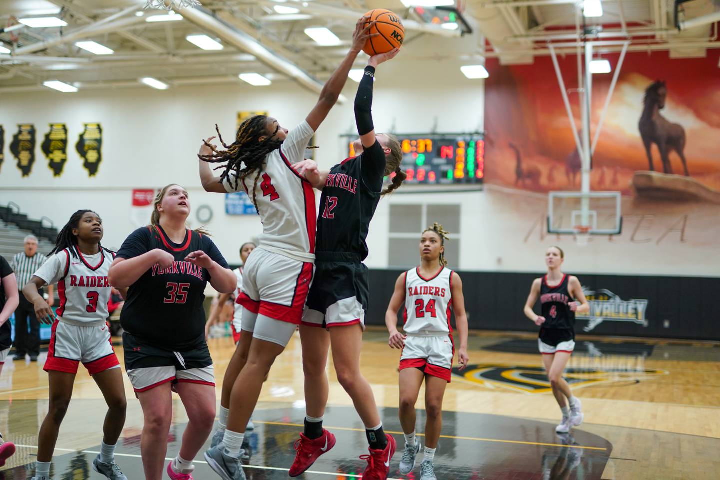 Bolingbrook's Sydney Dodd (4) blocks a shot by Yorkville's Elaine Gussman (12) during a Class 4A Metea Valley Regional final basketball game at Metea Valley High School in Aurora on Friday, Feb. 21, 2025.