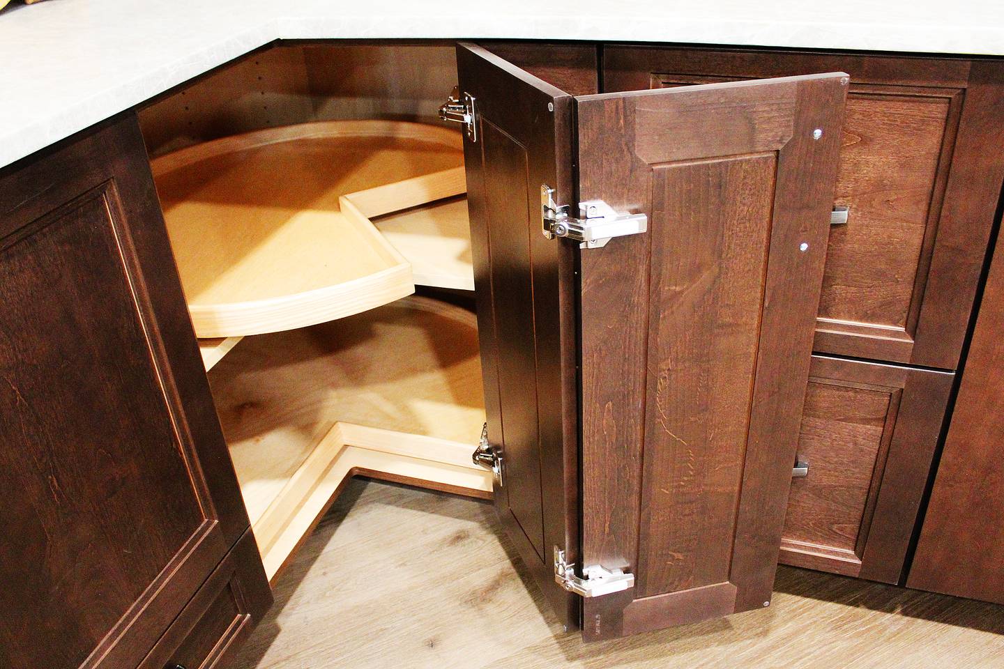 Recent trends in kitchen storage are on display at Sterling Woodworks' Lake Carroll showroom, including a lazy Susan whose jointed door pulls out and shelving pulls outward for improved ergonomics.