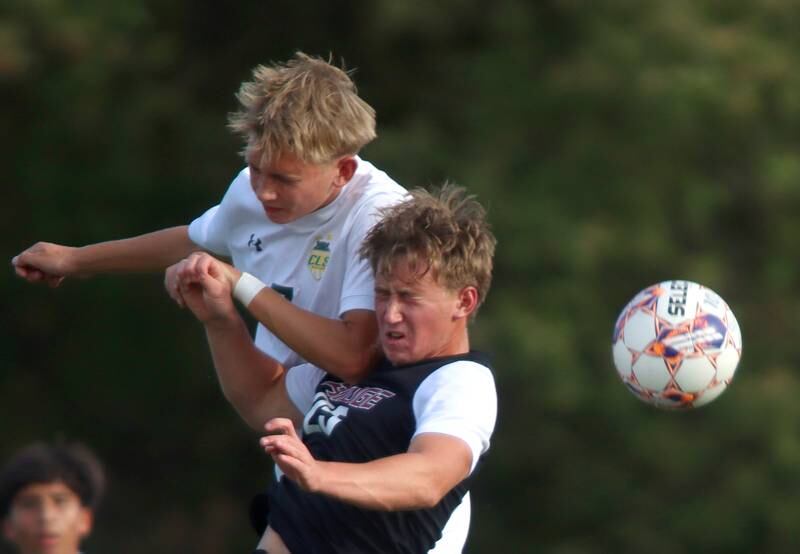 Crystal Lake South’s Will Prus, left, battles Prairie Ridge’s Jensen Schroeder, center, in varsity soccer on Thursday, Sept. 19, 2024, at Prairie Ridge High School in Crystal Lake.
