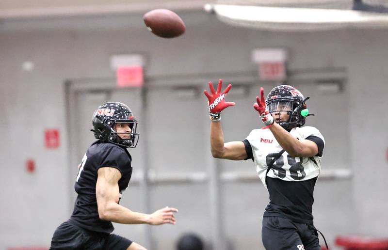 Northern Illinois receiver Malik Armstrong catches a pass behind safety Trey Porter during the teams first spring practice Wednesday, March 22, 2023, in the Chessick Practice Center at Northern Illinois University in DeKalb.