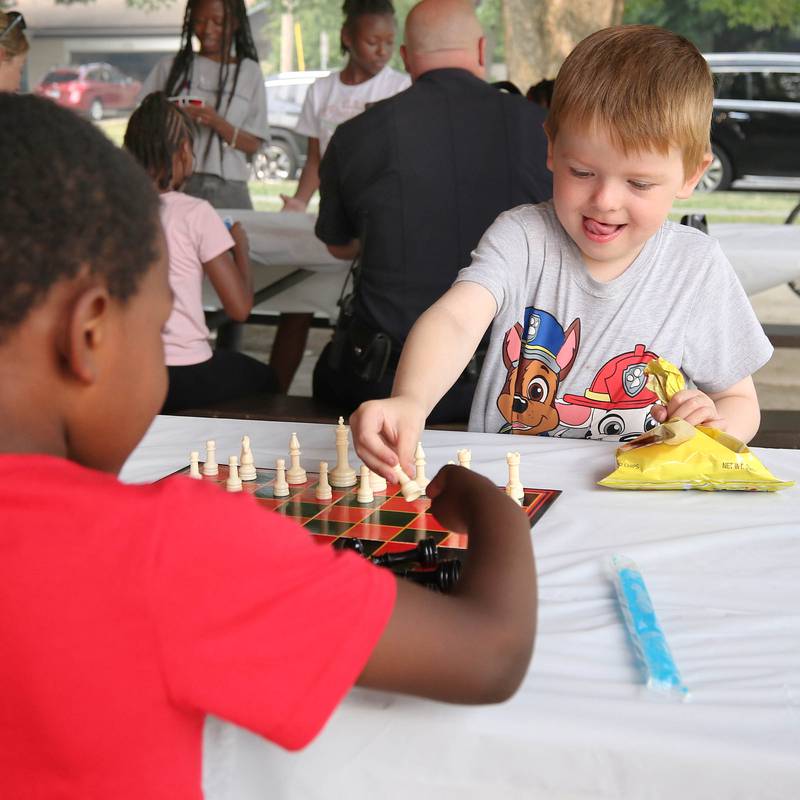 Westin Fickas, 6, (right) from DeKalb, makes a chess move during Fun Jam in the Park Tuesday, June 27, 2023, at Welsh Park in DeKalb. Fun Jam in the Park offers constructive activities for kids on Tuesday and Thursday through August 8th from 5-7 p.m. at various parks in DeKalb.