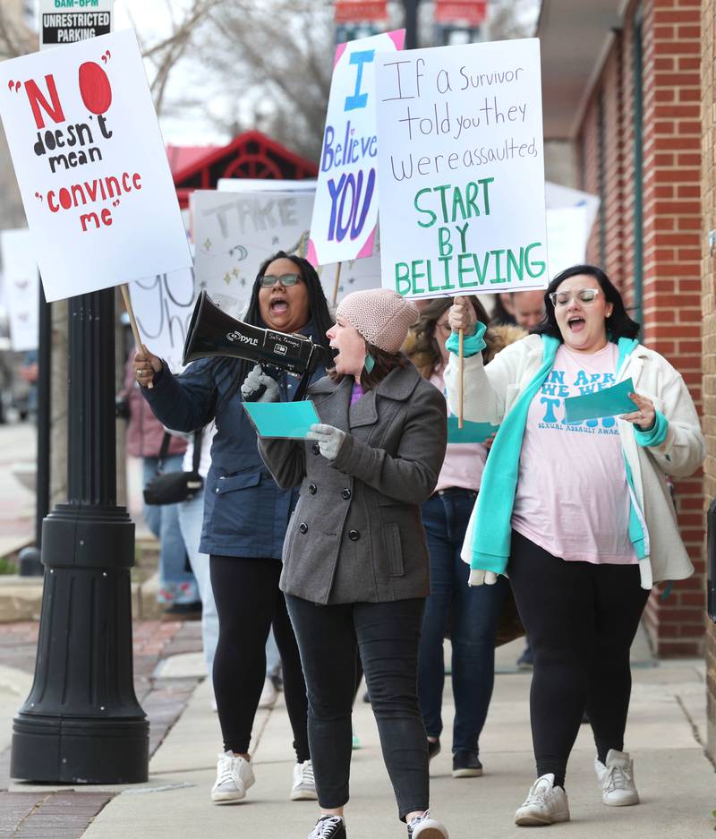 Marchers chant as they head down East Locust Street Monday, April 7, 2025, during the Safe Passage Take Back the Night and Survivor Speak Out in Dekalb. The event is held in conjunction with Sexual Assault Awareness Month.