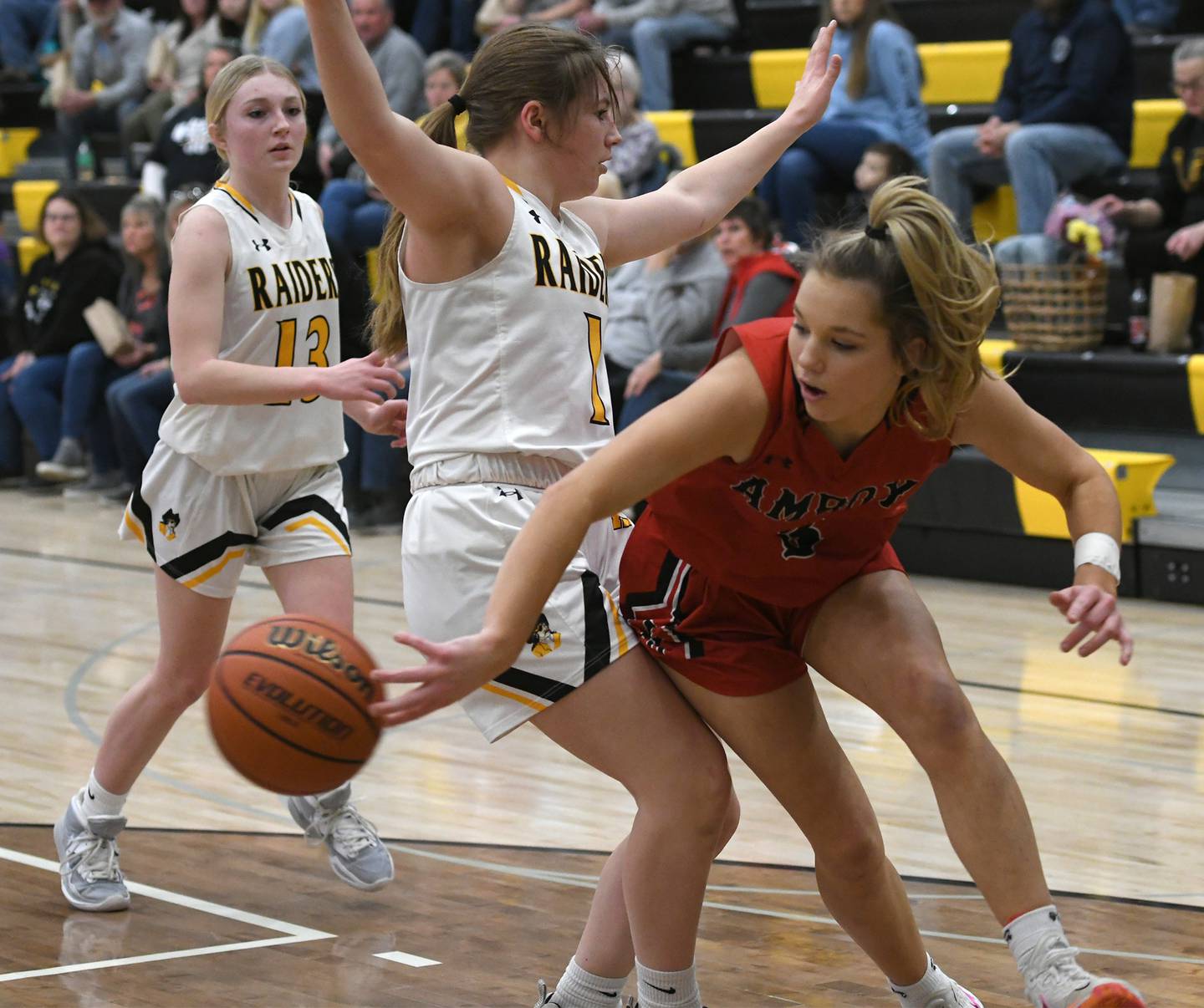 Amboy's Elly Jones (3) wraps a pass into the post around AFC's Alexis Schwarz during a Feb. 7 game in Ashton.