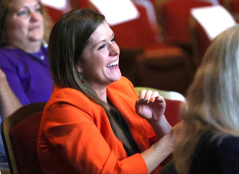 Donna Larson, an Athena Award finalist, laughs as she listens to her presenter Sara Jennings talk about her and why she is deserving to be nominated Thursday, Oct. 16, 2025, during the 35th annual Athena and Women of Accomplishment Award Reception at the Egyptian Theatre in DeKalb.