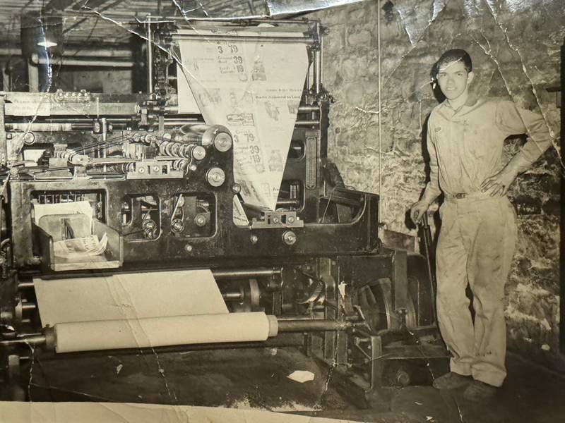 Cal Hammond with the printing press at the Morris Daily Herald office.