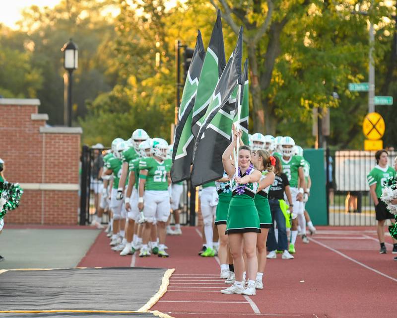 York Cheerleaders stand ready to lead the football team into the stadium before warmups in Elmhurst on Friday Sep. 1, 2023