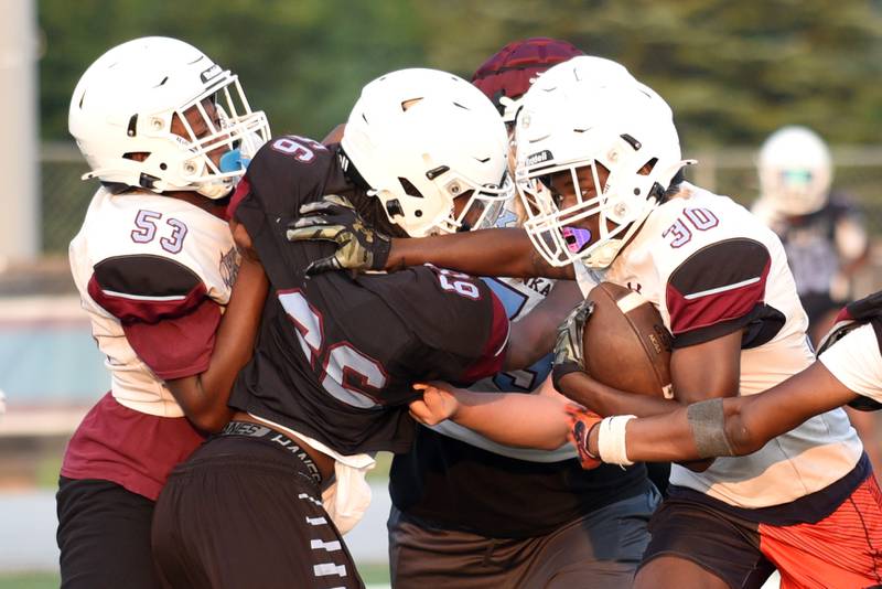 Kankakee's Omari Houston, right, runs through the defense during a scrimmage at the Kays' summer camp Thursday, July 31, 2025.