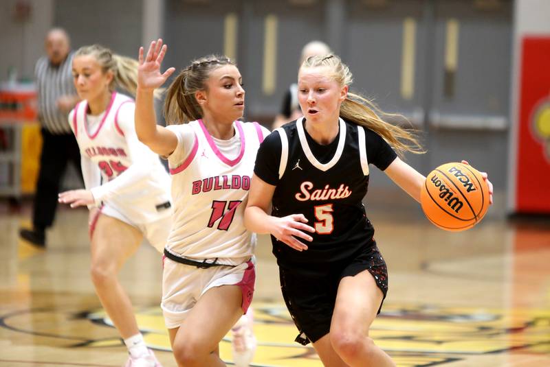 St. Charles East's Brooklyn Schilb drives toward the basket chased by Batavia's Kaidyn King during a game on Thursday, Feb. 6, 2025 in Batavia.