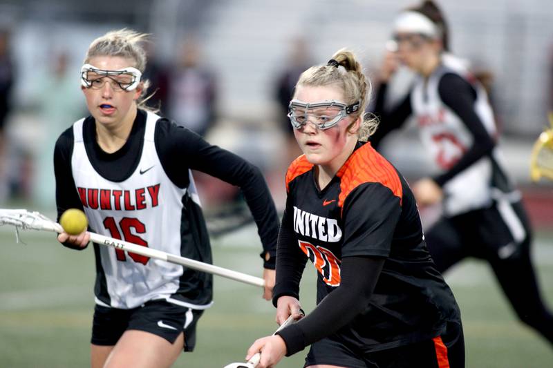 Huntley’s Katie Ferrara, left, races Crystal Lake Central’s Maddi Lieflander for the ball in varsity lacrosse at Huntley Wednesday.