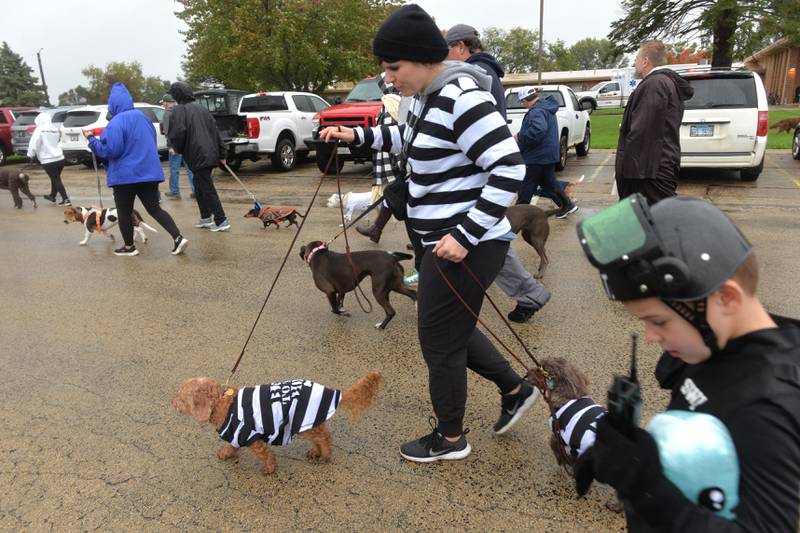 Julie Sanders and her pups Havek and Rukus came dressed as escaped convicts while Evynn and Brady Sanders, ages 3 and 6, were dressed as SWAT members at the Polo Student Council's Doggy Dash held Saturday, Oct. 14, 2023.