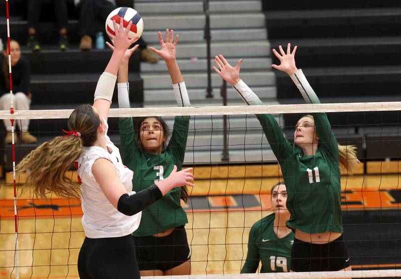 Fremd's Akshara Jay (left) and Natasa Radisic try to block the tip of Huntley's Georgia Watson Monday, Nov. 11, 2024, during their Class 4A supersectional match at DeKalb High School.
