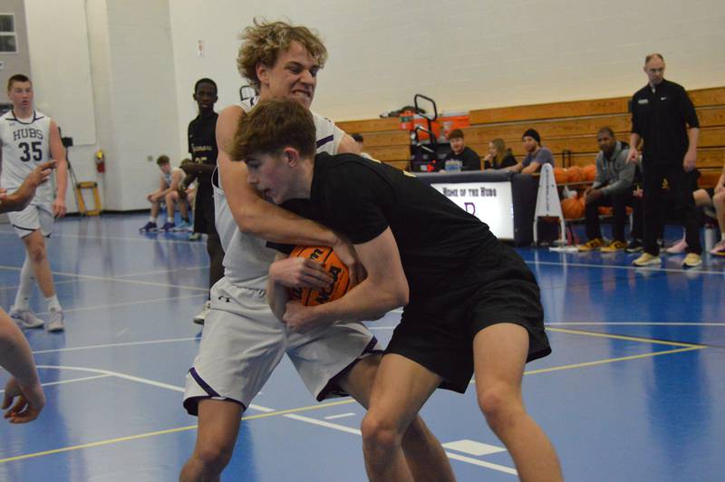 Rochelle's Braxton Bruns fights for a loose ball during the Hubs' sophomore game with Sycamore.