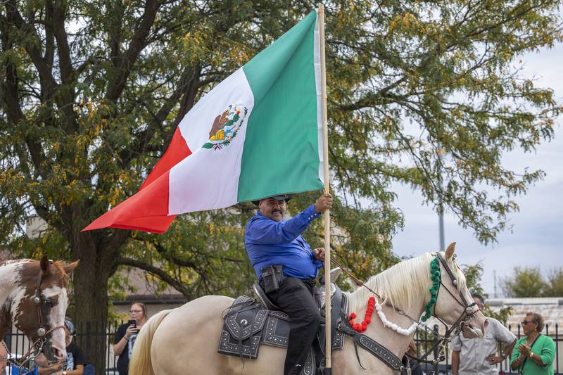 A flag bearer from Rancho El Capricho, displays the Mexican colors during the Fiesta Parade Saturday, Sept. 20, 2025, in Sterling.