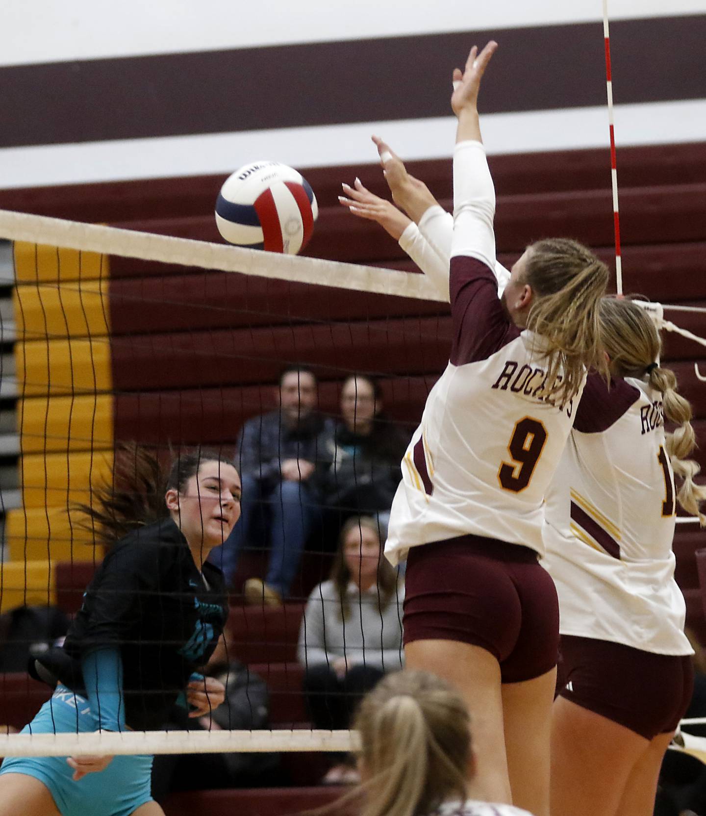 Woodstock North's Ava Kardaras (left) watches as Richmond-Burton's Reagan Wisniewski (center) and Zoe Freund (right) block her hit during a Kishwaukee River Conference volleyball match on Wednesday, Oct. 15, 2025, at the Richmond-Burton High School in Richmond.