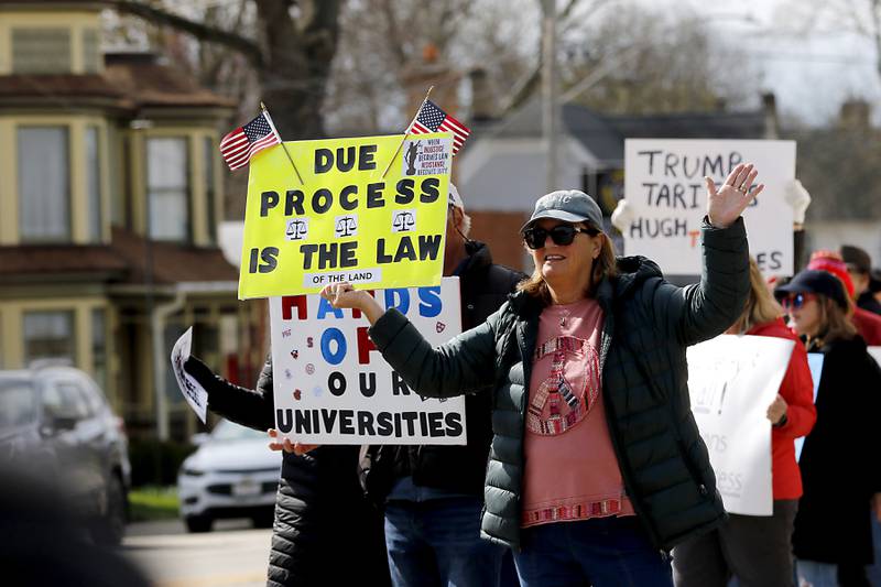 Protesters line U.S. Route 12 in Richmond to protest their discontent with President Donald Trump and his administration's policies on Saturday, April 19, 2025. Over 100, people took part in the Richmond protest. A second rally was held in Harvard later in the day.