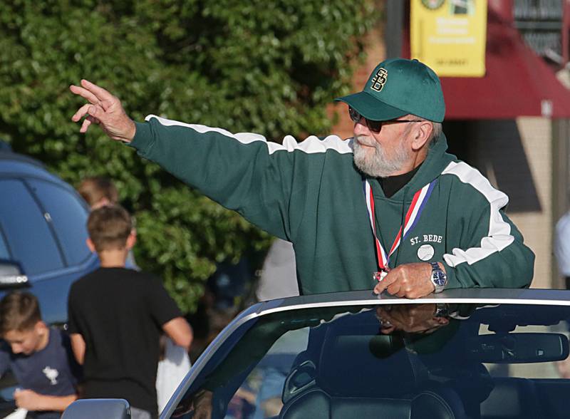 St. Bede Abbot Philip Davey OSB, waves to people while riding in the Homecoming parade on Friday, Sept. 30, 2022 downtown Peru.