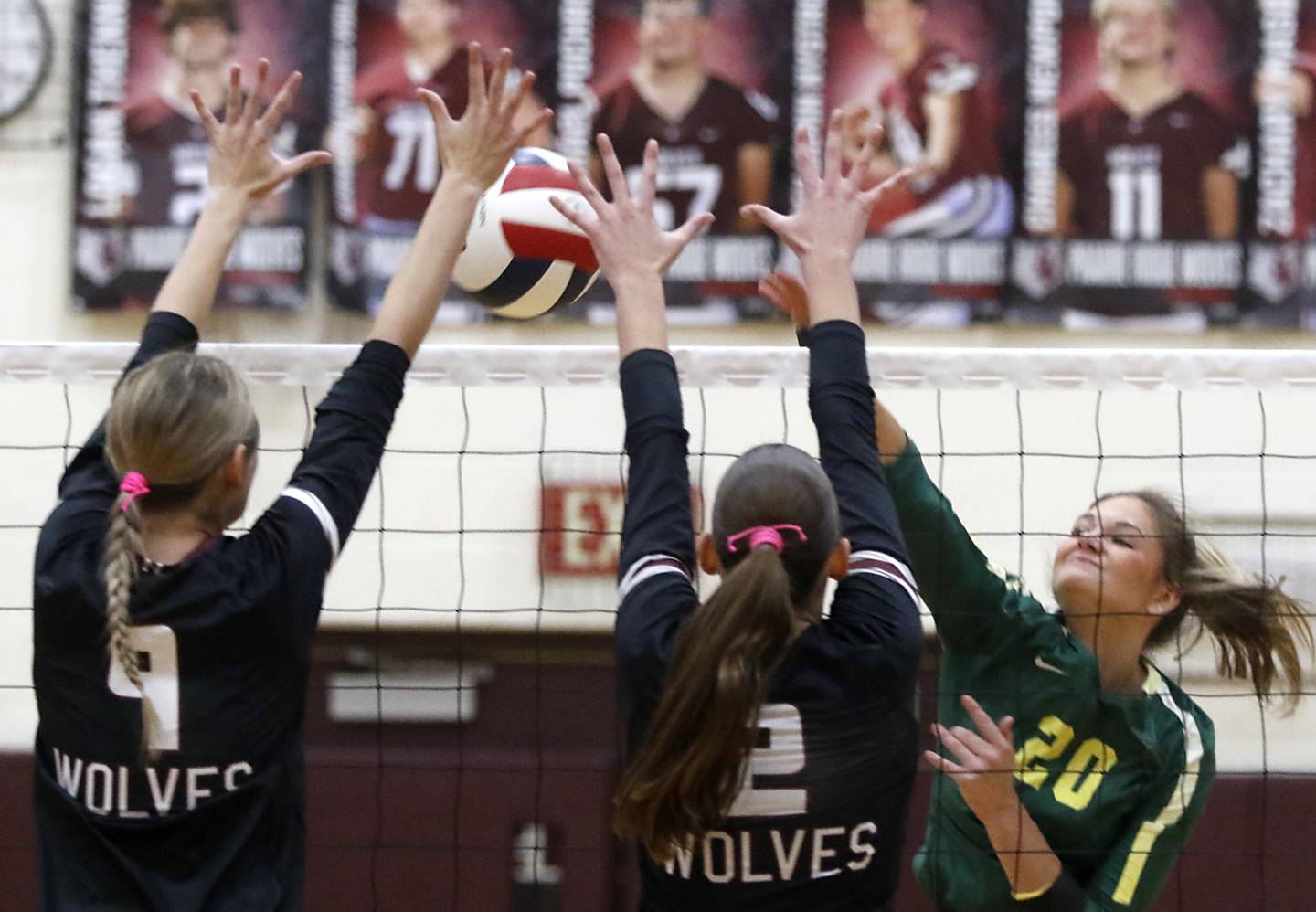 Crystal Lake South's Bobbi Wire (right) hits the ball into the block of Prairie Ridge's Addison Smith (center) and Harleigh Serpico (right) during the IHSA Class 3A Prairie Ridge Regional championship volleyball match on Thursday, Oct. 30, 2025, at the Prairie Ridge High School in Crystal Lake.