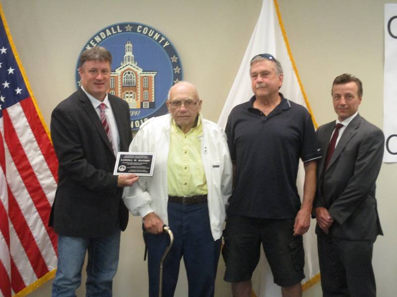 Lowell Mathre of Newark, 92, was honored  by the Kendall County Historic Preservation Commission on May 16, 2023. From left is Kendall County Board Chairman Matt Kellogg, Mathre, Preservation Commission Chairman Jeff Wehrli and commission member Marty Shanahan.
