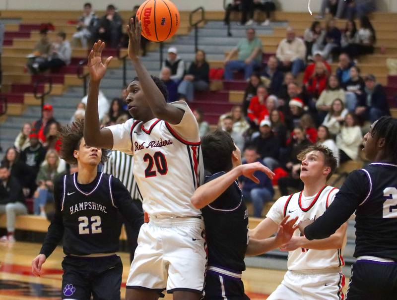 Huntley’s Isaiah Onu battles for the ball against Hampshire in varsity boys basketball on Friday, Dec. 19, 2025, at Huntley High School in Huntley.
