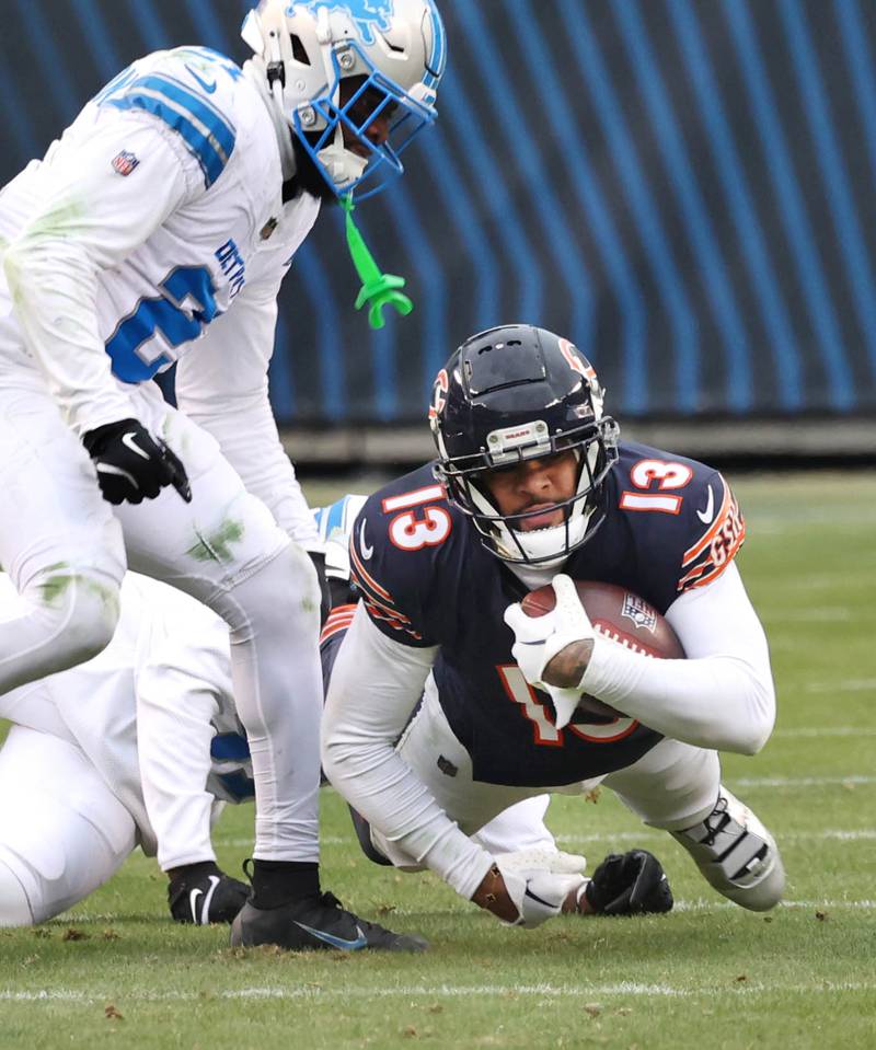 Chicago Bears wide receiver Keenan Allen dives for extra yardage while being brought down by two Detroit Lions defenders during their game Sunday, Dec. 22, 2024, at Soldier Field in Chicago.