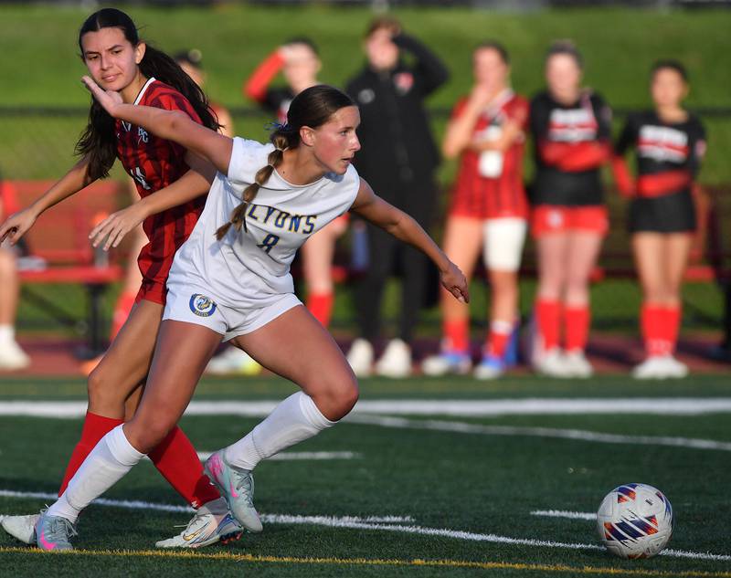 Lyons Township’s Carolina Capizzi (8) goes after the ball after untangling with Hinsdale Central’s Maria Leal during a game on April 29, 2025 at Hinsdale Central High School in Hinsdale.