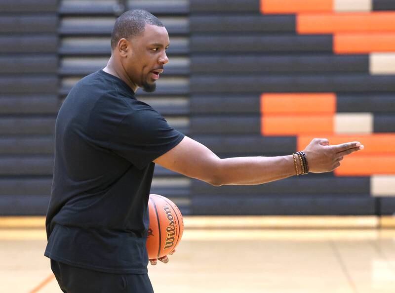 Julian McElroy, an assistant basketball coach at DeKalb High School, gives some instruction during a TRUTH Basketball Academy session Tuesday, June 25, 2024, at the school.