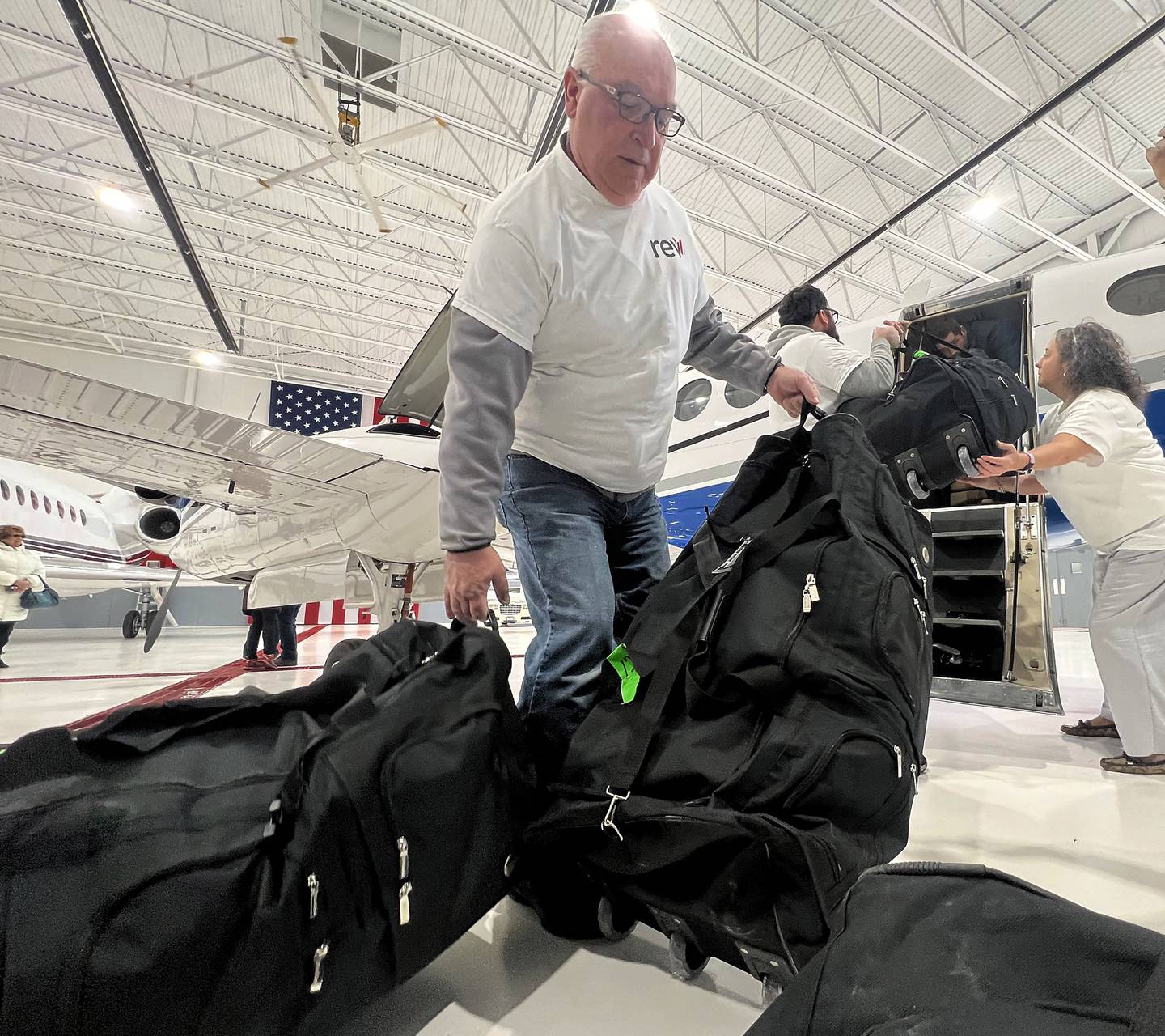 Employees from Revv Aviation located at the Aurora Municipal Airport load up bags of supplies that include toiletries, combat gear that includes tourniquets, medical supplies and crutches which will be flown to John F. Kennedy International Airport in New York City then on to Poland for the Ukrainian refugees.