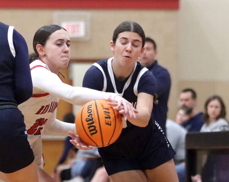 Huntley’s Luca Garlin, left, battles Cary-Grove’s Kennedy Manning for the ball in varsity girls basketball on Monday, Feb. 2, 2026, at Huntley High School in Huntley.