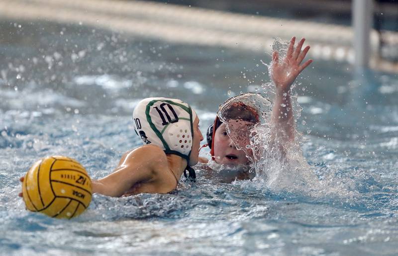 Hersey's Avery Born (20) tries to stop a shot by YorkÕs Rose Jensen (10) during the IHSA State Water Polo consolation match Saturday May 20, 2023 at Stevenson High School in Lincolnshire.