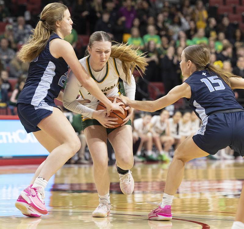 Waubonsie Valley’s Hannah Laub handles the ball against Nazareth Academy’s Mary Bridget Wilson (right) and Danielle Scully Friday, March 1, 2024 in the girls basketball 4A state semifinal at CEFCU Arena in Normal.