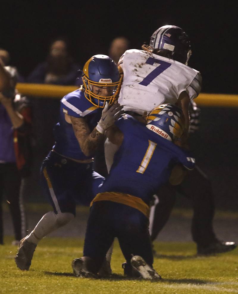 Johnsburg's Ian Boal, left, and Jake Metze, right, try to tackle Rochelle's Erich Metzger during a IHSA Class 4A second round playoff football game Friday, Nov. 4, 2022, between Johnsburg and Rochelle at Johnsburg High School in Johnsburg.