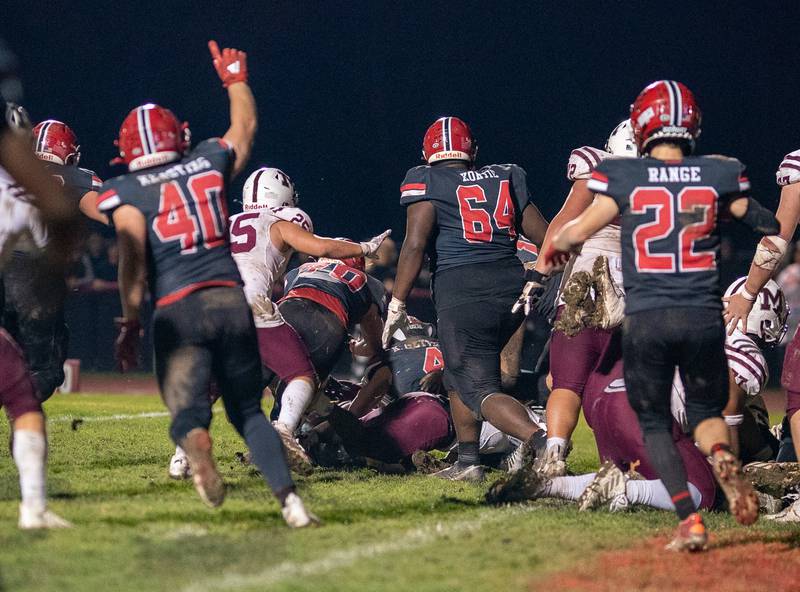 Yorkville stops a run attempt by Moline’s Riley Fuller (4) to secure the victory in quadruple overtime over Moline to advance to the 7A quarter finals at Yorkville High School on Friday, Nov 4, 2022.