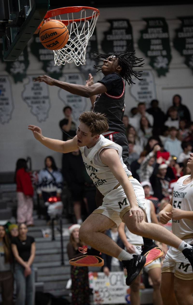 Bishop McNamara's Teddy Fogel, front, tosses up a lay-up as Chicago Bulls Prep's Mekhi Slaughter, back, guards in a game on Friday, December 19, 2025.