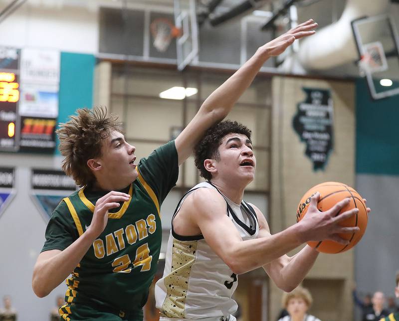 Sycamore's Marcus Johnson shoots the ball in front of Crystal Lake South's Vincent Santarelli during an IHSA Class 3A Woodstock North Sectional semifinal.basketball game on Wednesday, March 4, 2025, at Woodstock North High School.
