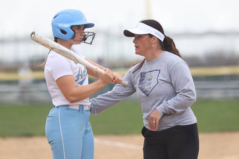 Joliet Catholic head coach Tina Kinsella talks with Brook Baranoski before her at-bat against Plainfield South on Wednesday, April 10, 2024.