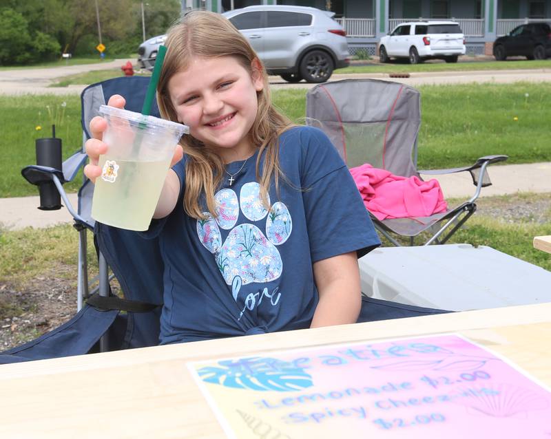 Evelyn Sereno of Utica, holds a glass of her lemonade that she sold during the 2nd Annual Lemonade Day for Young Entrepreneurs on Saturday, May 4, 2024 at Country Kids in Utica.