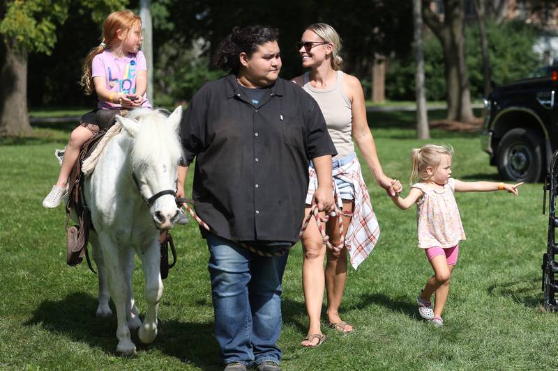 Brooklyn, 5-years old, rides a horse along side her mother Theresa Debellis and sister Brianna, 3-years old at the Autumn Family Fun Fest on Saturday, Sept. 23, 2023 in Plainfield.