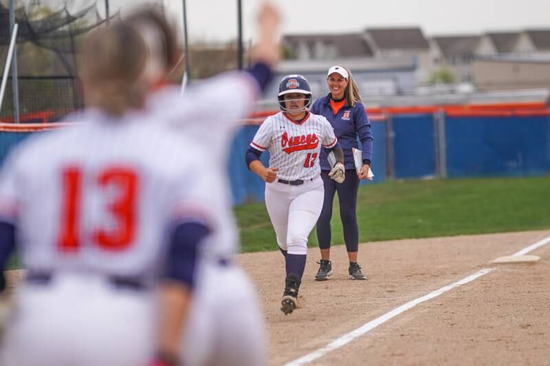 Oswego’s Aubriella Garza (12) rounds third base after hitting a three run homer against Oswego East during a softball game at Oswego High School on Thursday, April 18, 2024.